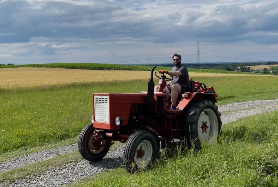 The author driving a small old tractor on a farm track